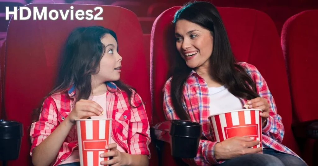 a person and a child sitting in a movie theater hdmovies2